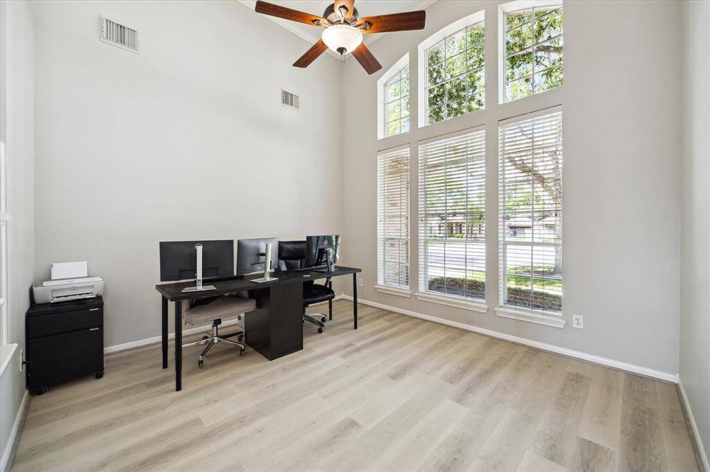 This is a wonderful space overlooking the front yard with soaring ceilings and gorgeous oversized arched windows