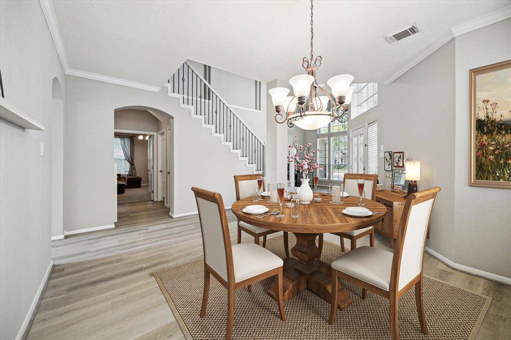 The formal dining area greets guests opposite the stairway- virtually staged