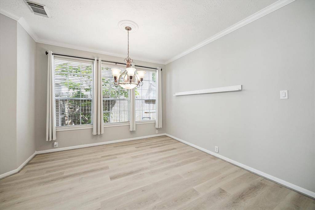 Expansive windows fill the formal dining area with natural light.