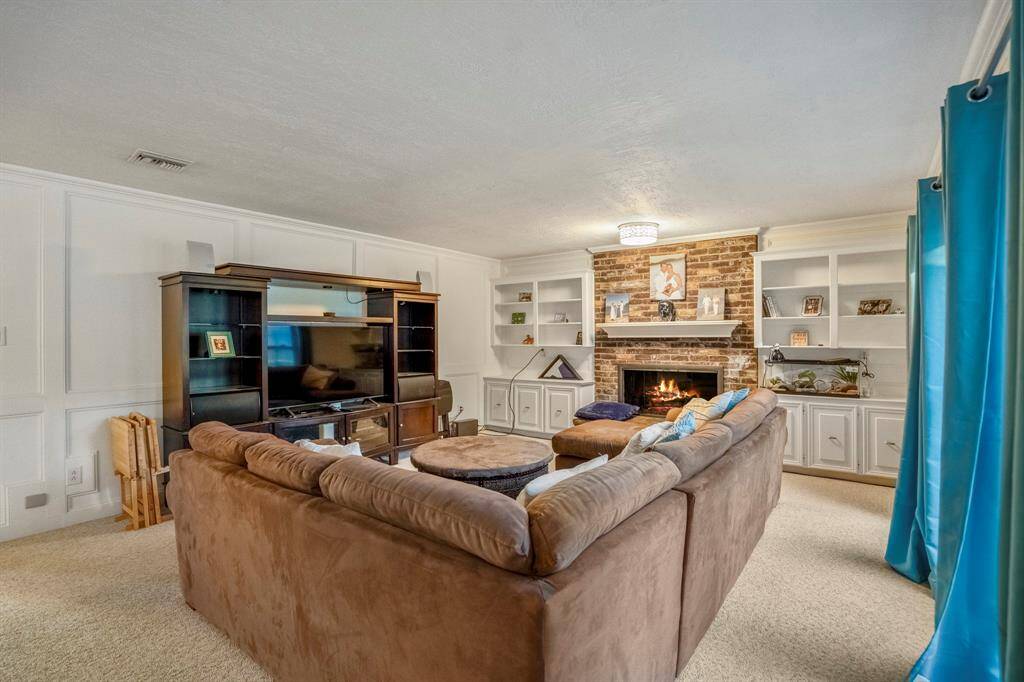 From the kitchen and breakfast area, you'll enter the main living area, accented by a fireplace and windows to the back yard.