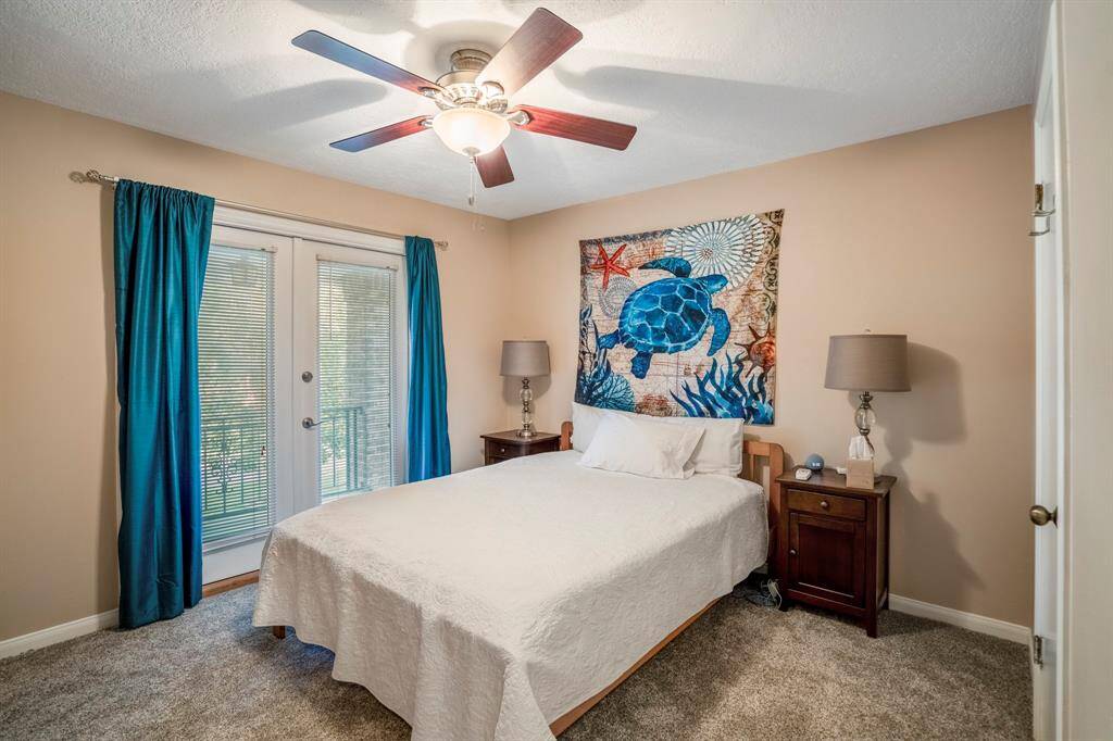 One of two secondary bedrooms that open to the front balcony, with a walk-in closet.