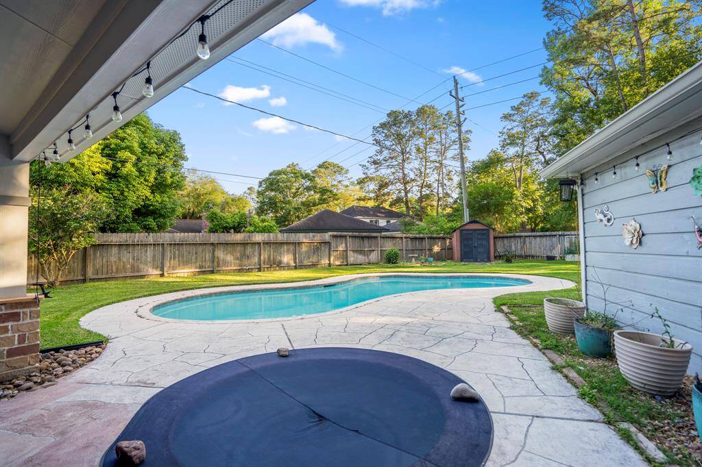 The covered patio, hot tub, and pool!  The pool has been resurfaced, the pool heater, filter and blower have all been updated.  This back yard is ready for summer!