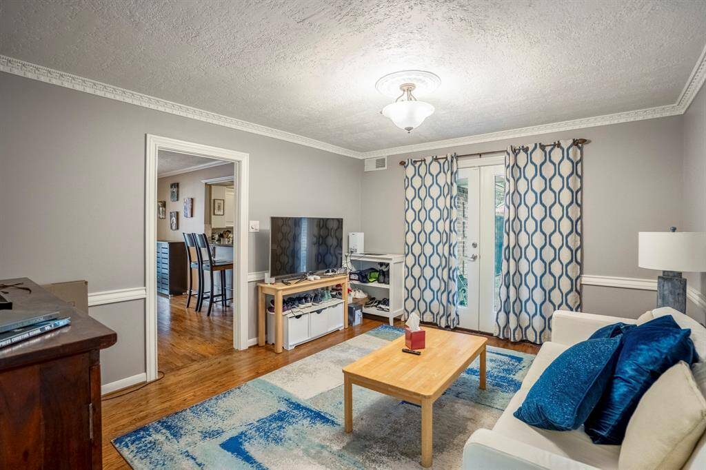 The formal dining room is being used as a den.  The french doors lead to a small side covered patio.