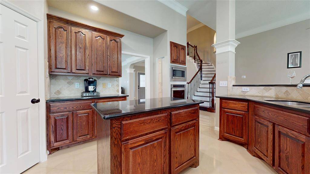 This spacious kitchen features an island offering additional workspace.
