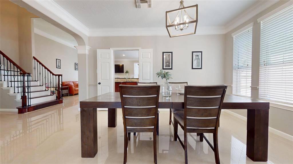 Dining area with accented by a stylish light fixture is accessible by the kitche. The Dining Area features large windows allowing ample natural light. Perfect for any occasion.