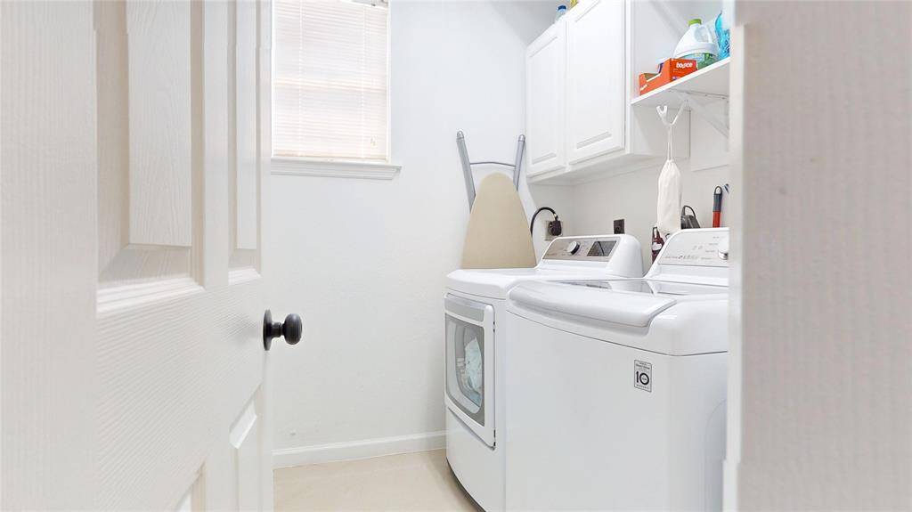 Laundry Room located on the first floor contains storage cabinets and shelves for conveience.