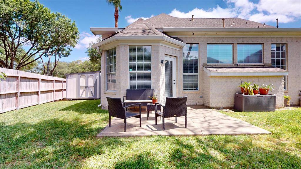 Charming backyard with patio area perfect for outdoor seating. The yard features a storage shed that was recently added and painted. The privacy fencing surrounds the backyard making ideal for relaxation and entertaining.