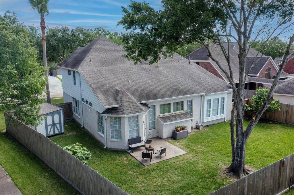 Another view of the backyard featuring plenty of space to entertain and play.