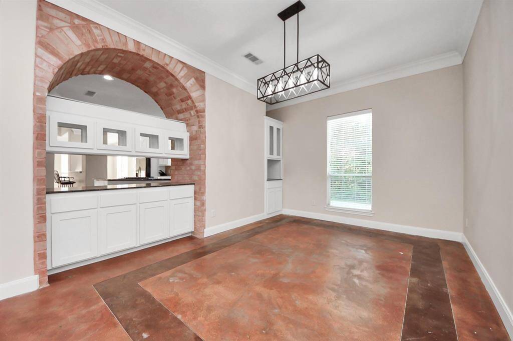 Continuing through the entryway, you’re led into the heart of the home: a beautifully appointed formal dining room