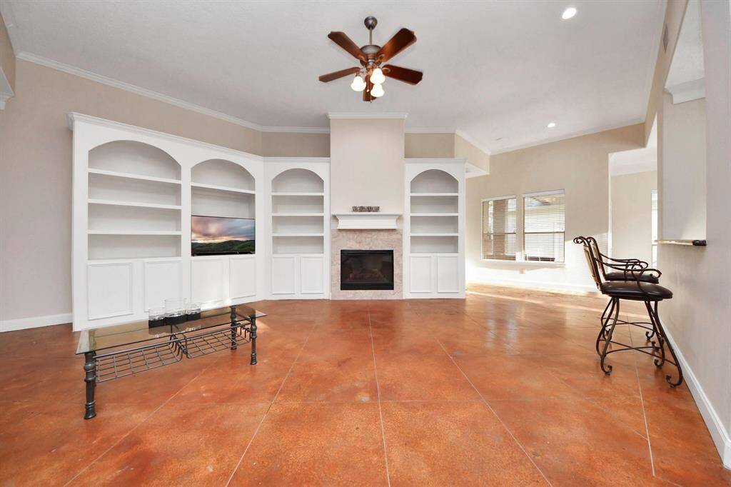 The living area features custom built-in shelving, offering both functionality and a stylish focal point—perfect for displaying books, décor, or media equipment.