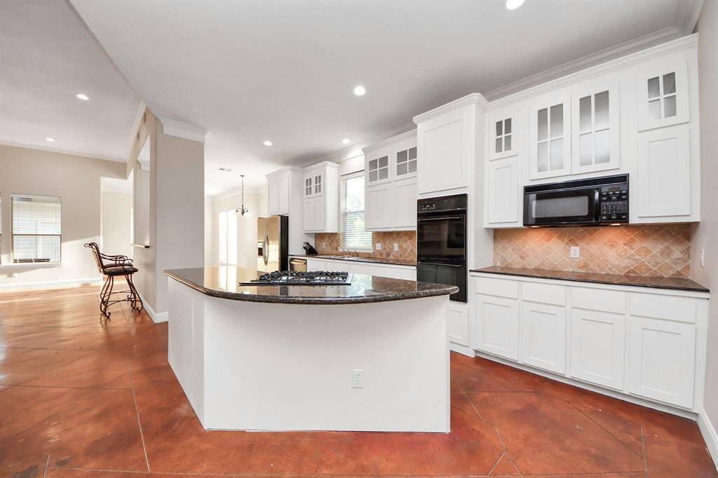 Beautiful cabinetry offers abundant storage, while clean lines and high-end finishes add to the overall elegance of the space.