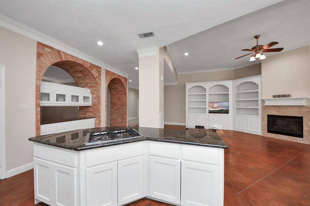 Anchored by a large central island, there’s ample space for meal prep, casual dining, or gathering with family and friends.