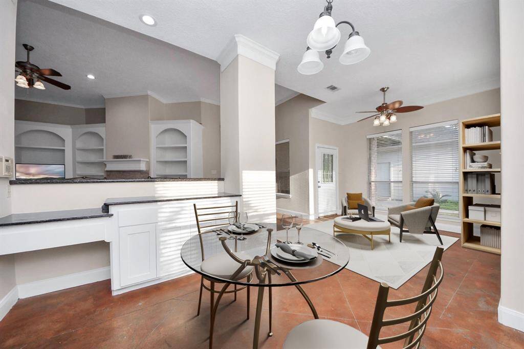 Just off the kitchen, you’ll find a charming sunroom that serves as a cozy and casual space for morning coffee.