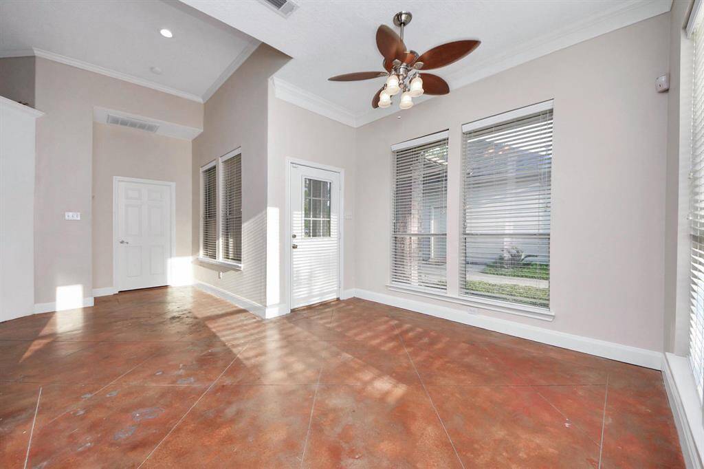 Natural light pours in through the windows of the sunroom, creating a bright and productive atmosphere.