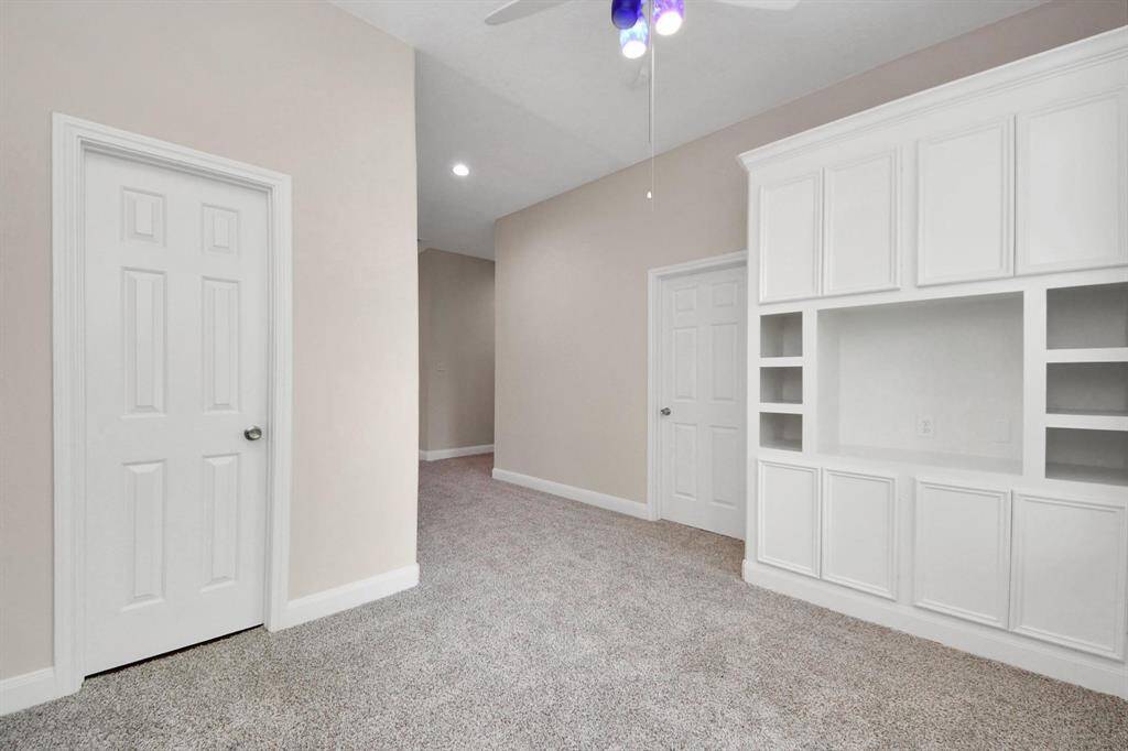 A standout feature in all three rooms is the custom built-in cabinetry—a rare and thoughtful addition that provides stylish storage and display options.