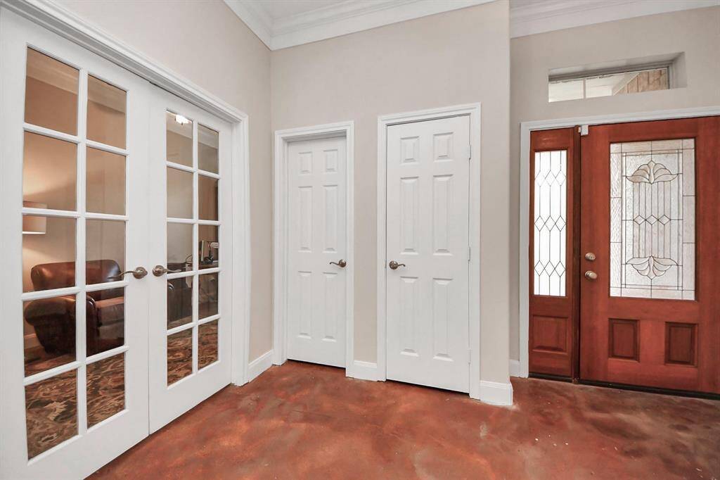 Just off the entry, through a set of double glass French doors, you’ll find a dedicated home office or formal study