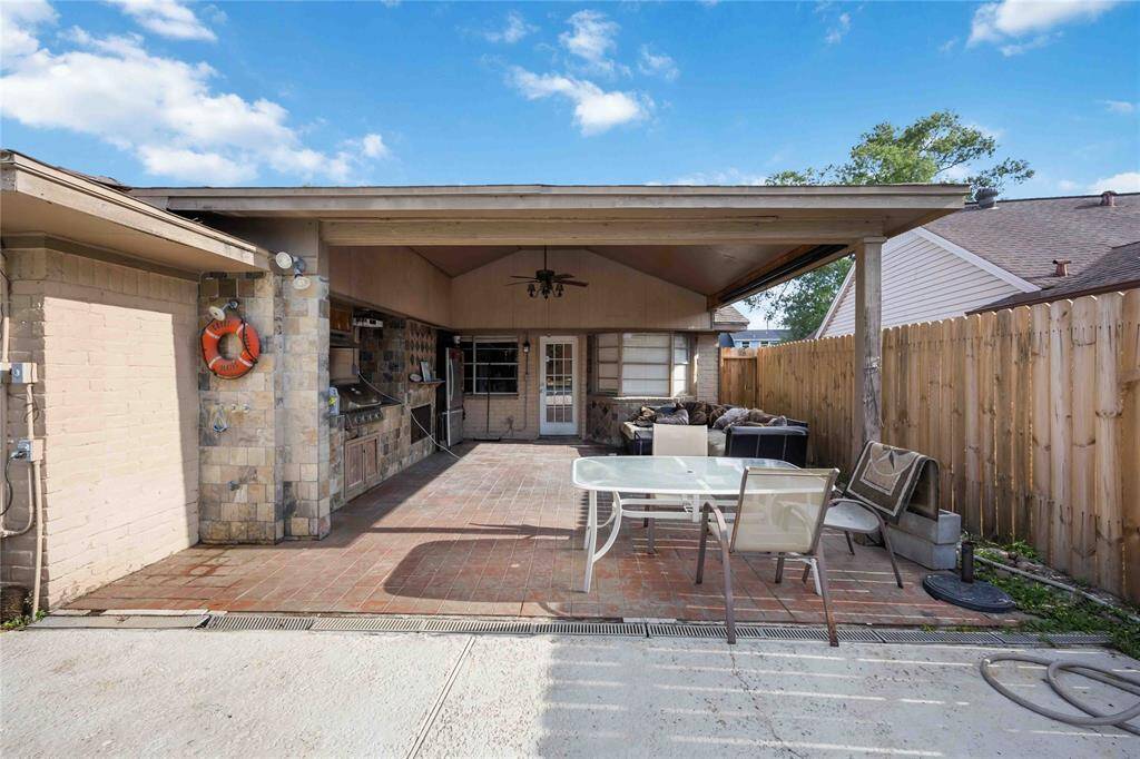 porte-cochère covered patio, with outdoor kitchen & wood burning fireplace