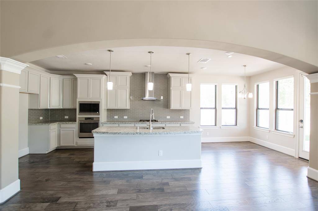 Kitchen boasts a large island open to living area, perfect for entertaining