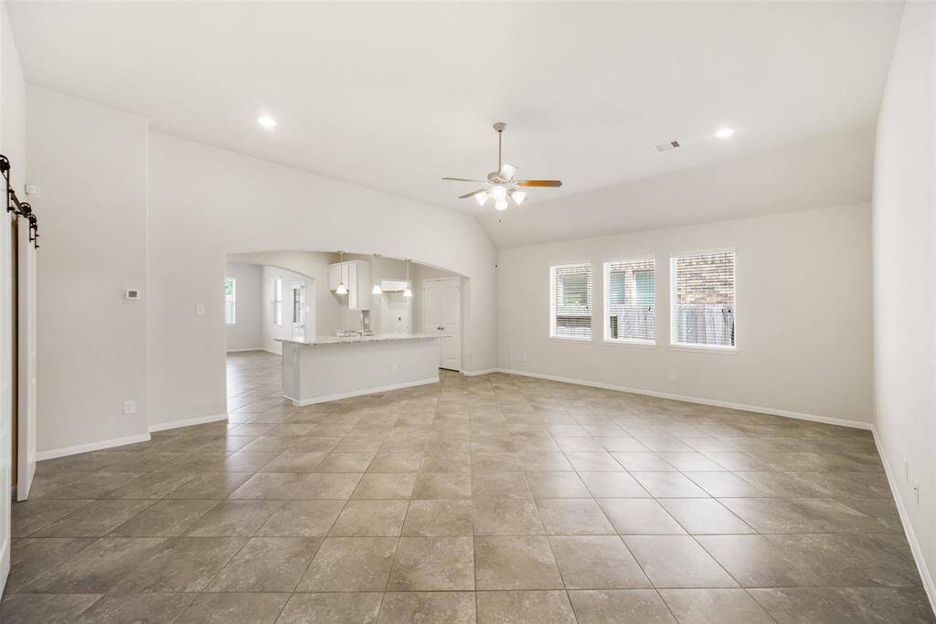 A view from the front of the family room looking into the kitchen, showcasing the open layout and seamless flow between the spaces.
