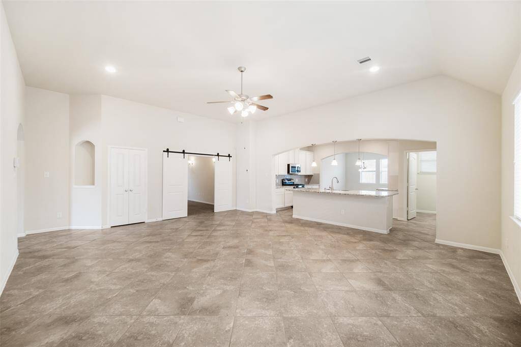 This alternate view of the family room highlights the convenient eat-at bar top, perfect for casual dining or entertaining.