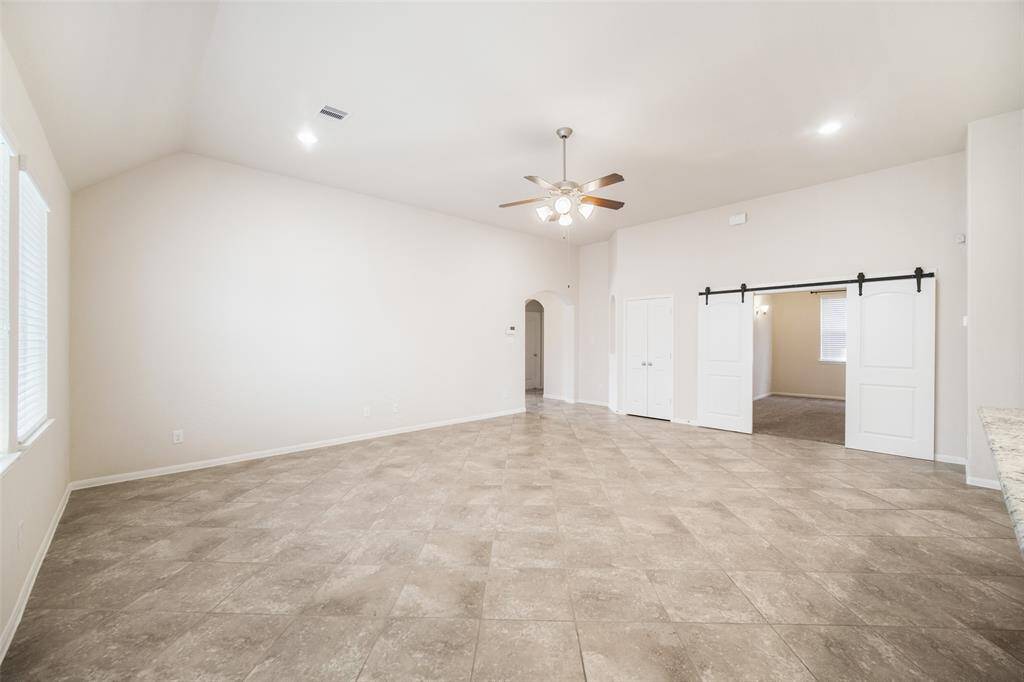 This alternate view of the family room highlights the charming barn doors that lead into the media room.