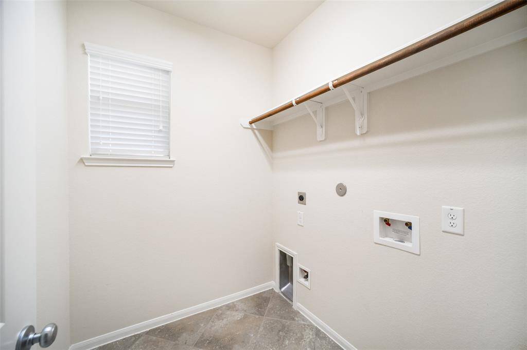 The utility room is conveniently located inside the home, just off the kitchen offering easy access for everyday laundry.