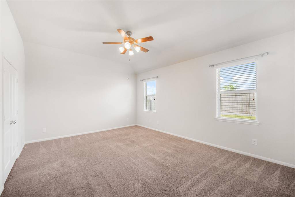 Natural light fills the primary bedroom, enhancing its warmth and charm.