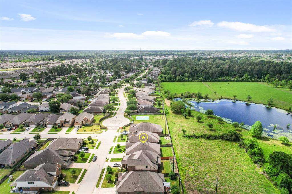 Aerial side view showcasing the home’s placement and surroundings within the community.