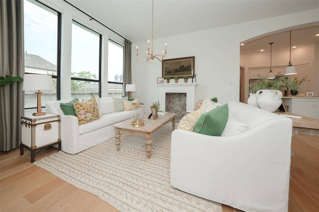 Effortlessly control natural light with sleek electric shades in the living room.