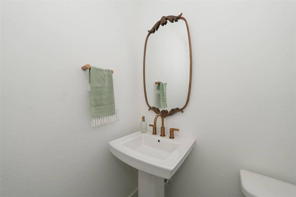 Convenient half bath adjacent to the study, perfect for guests.