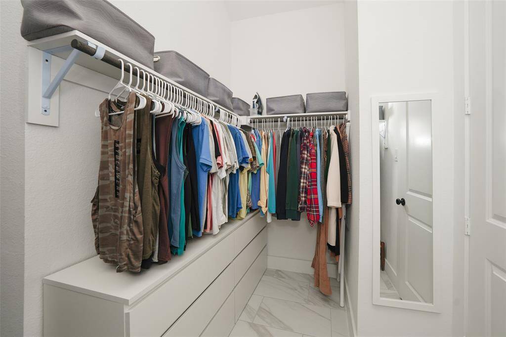 Spacious walk-in closet with ample storage.