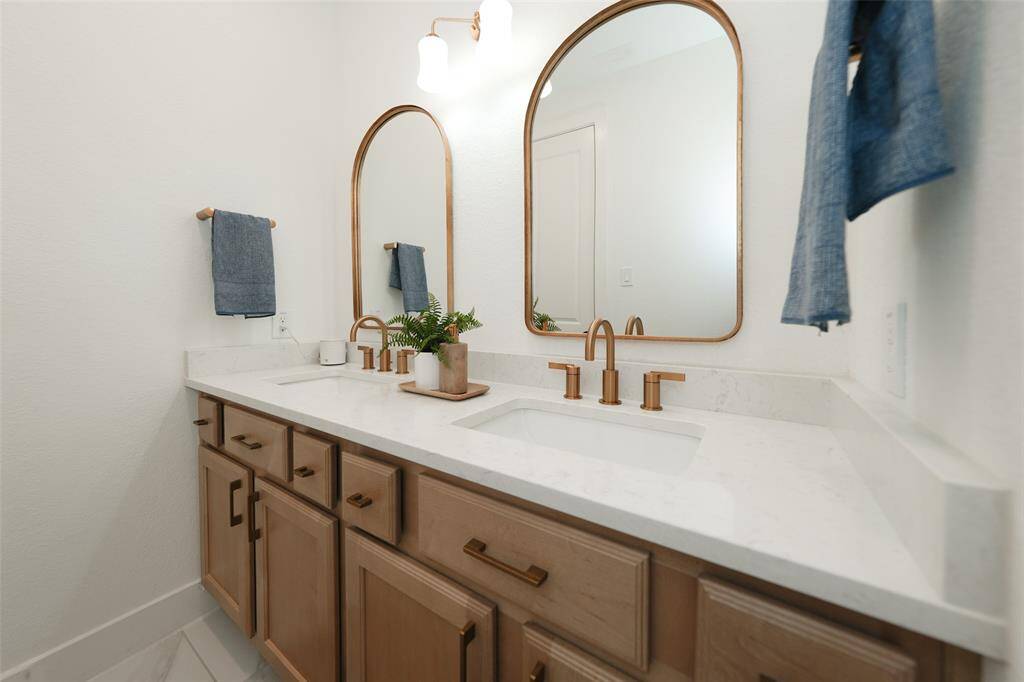 Spacious third bathroom with elegant double sinks.