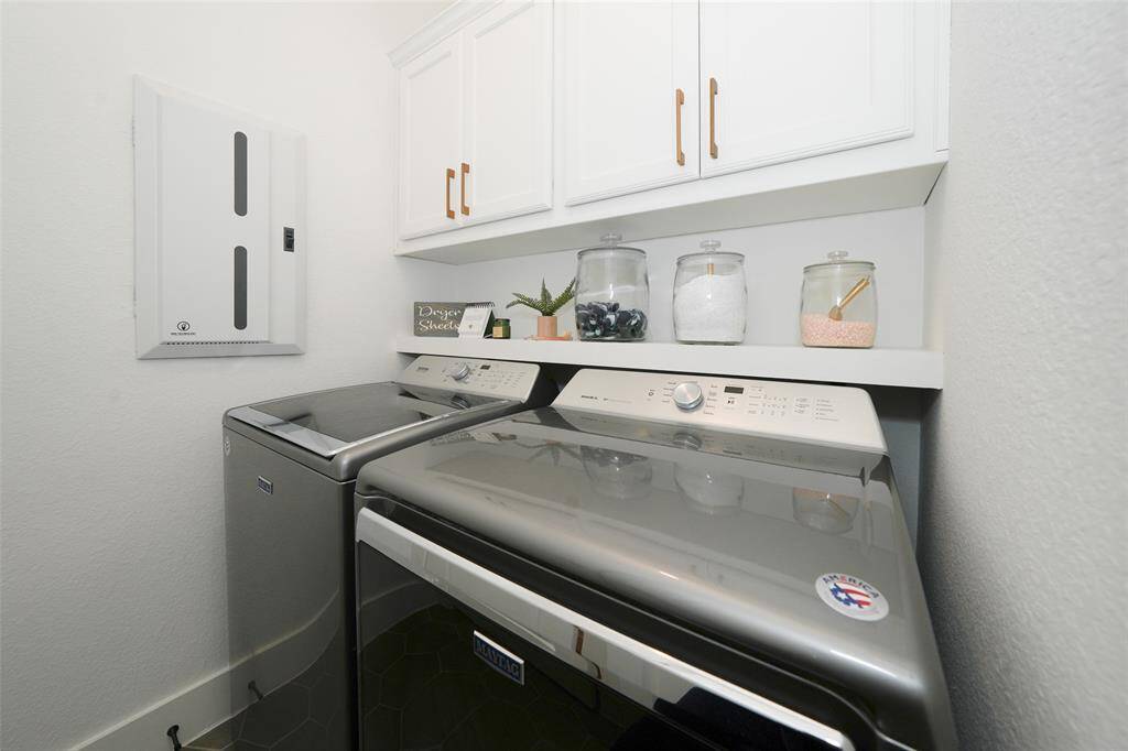 Efficient utility room featuring modern appliances and ample storage space.