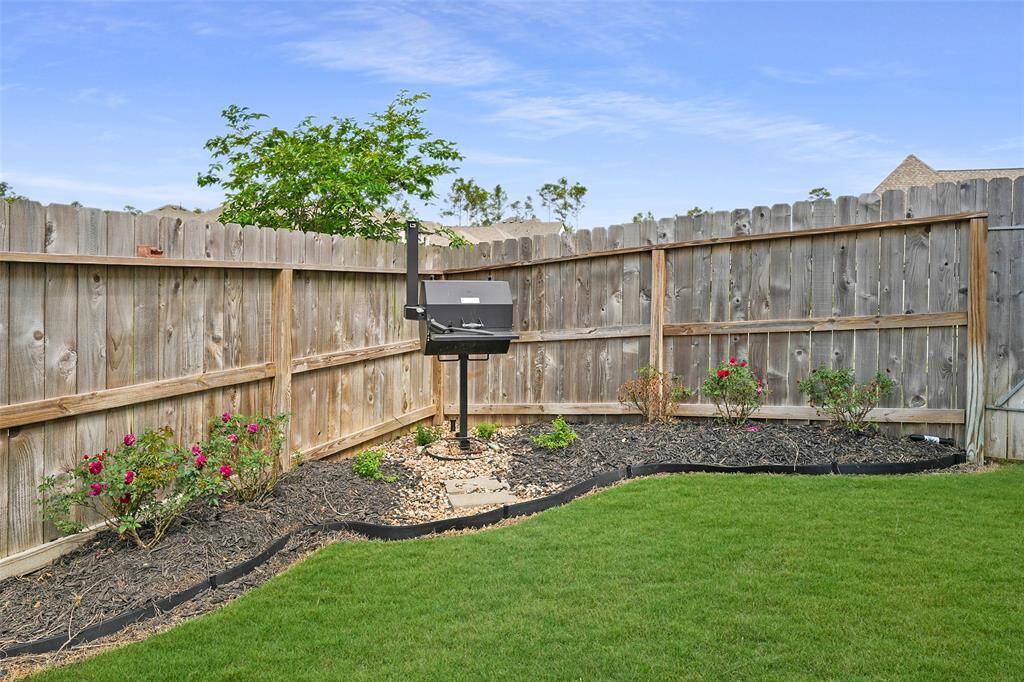 Enjoy outdoor cooking with a versatile wood or coal BBQ, perfect for gatherings in your backyard oasis.