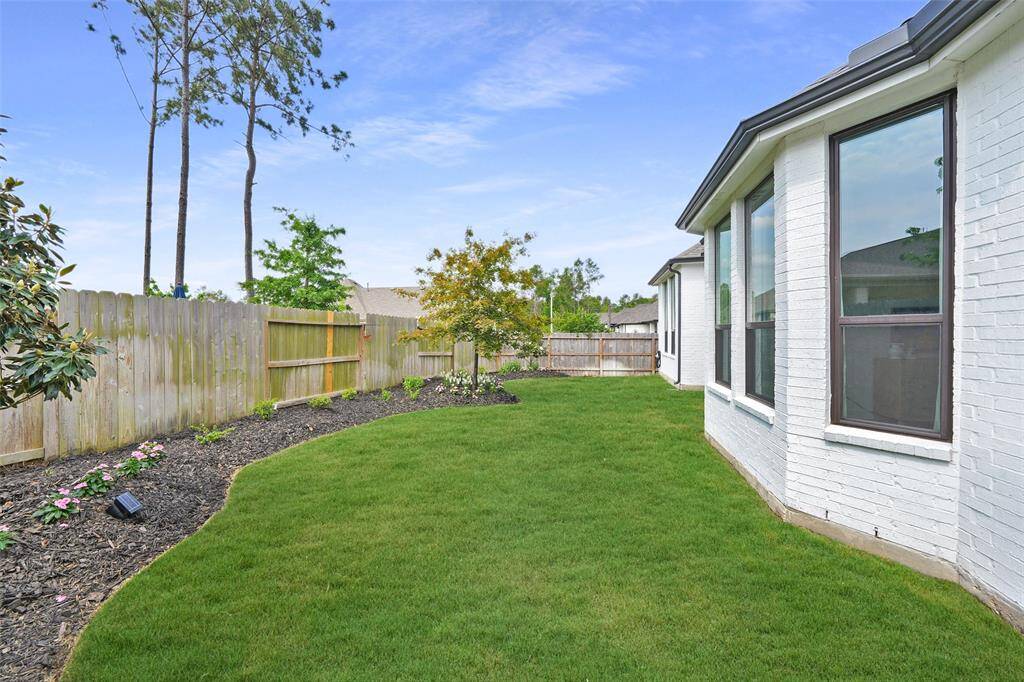 Experience the charm of the spacious primary suite with a stunning bay window, flooding the room with natural light and offering serene views of the landscaped backyard.