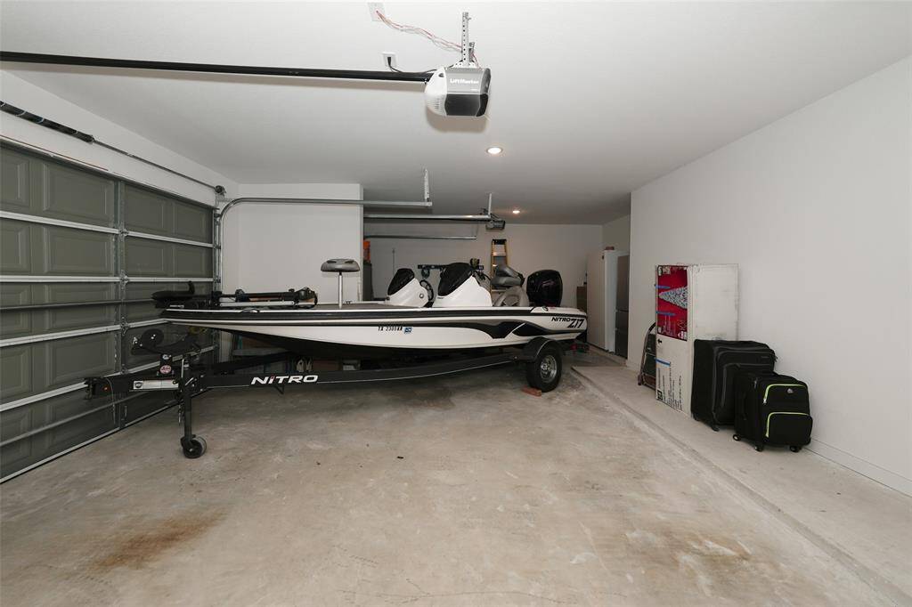 Spacious three-car garage with ample storage and versatile space for vehicles and more.