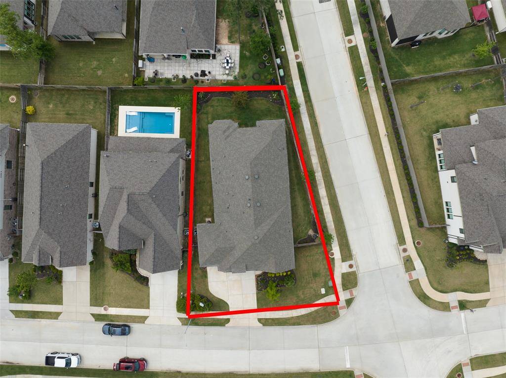 Spacious driveway with a three-car garage for ample parking and storage.