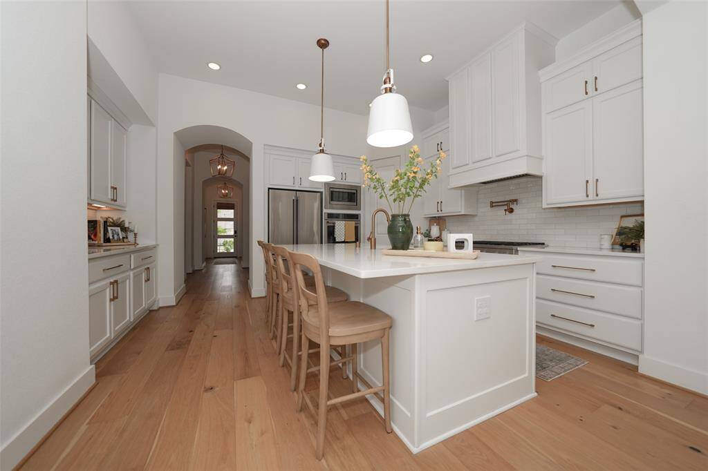 Expansive island with elegant custom lighting.