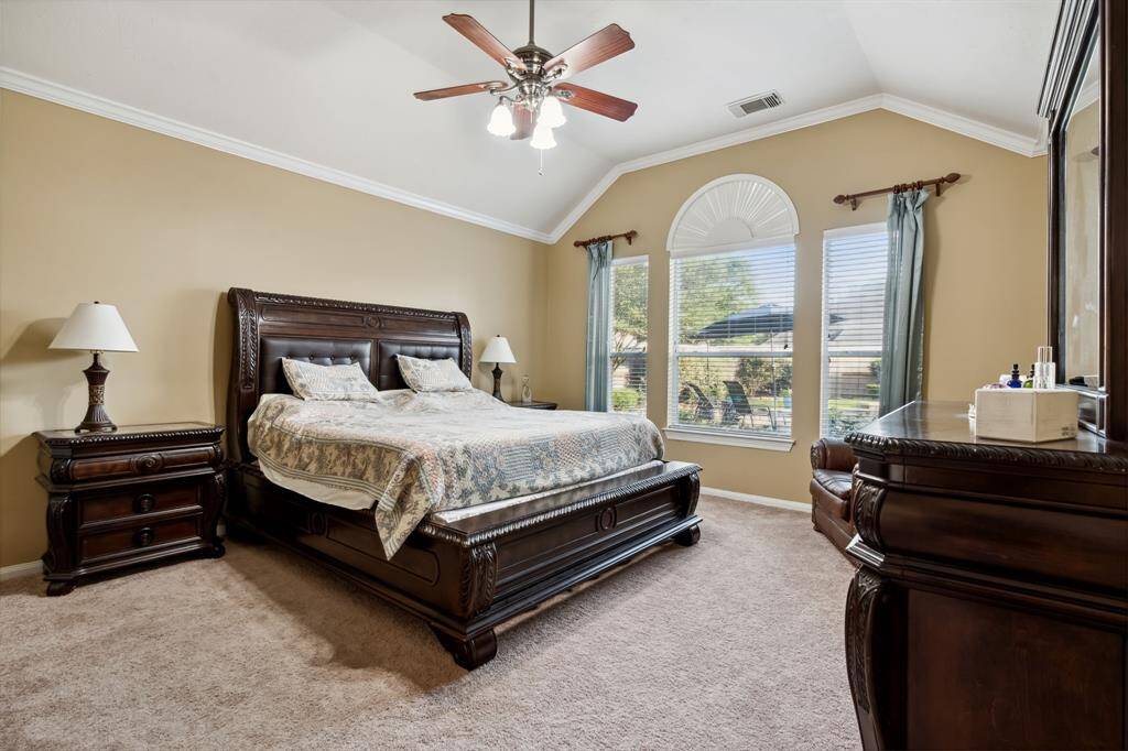 Downstairs primary suite. Raised ceiling with crown moulding, breezy ceiling fan. Amazing pool views!