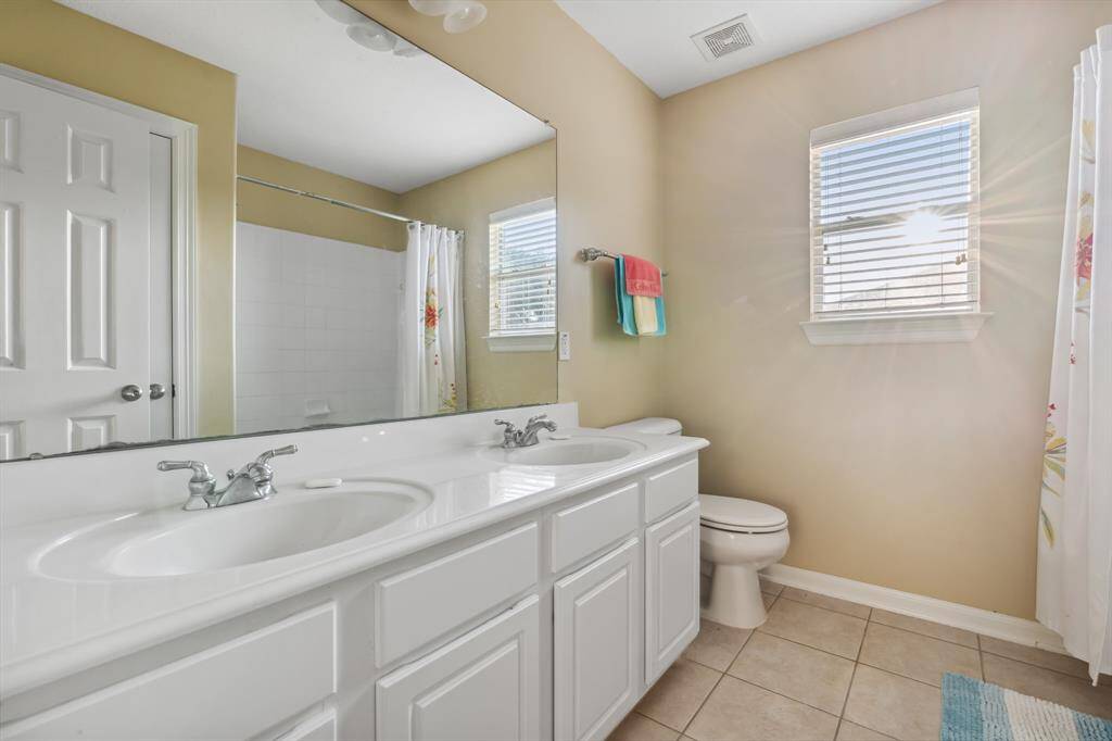 Upstairs full bathroom with double sink vanity.