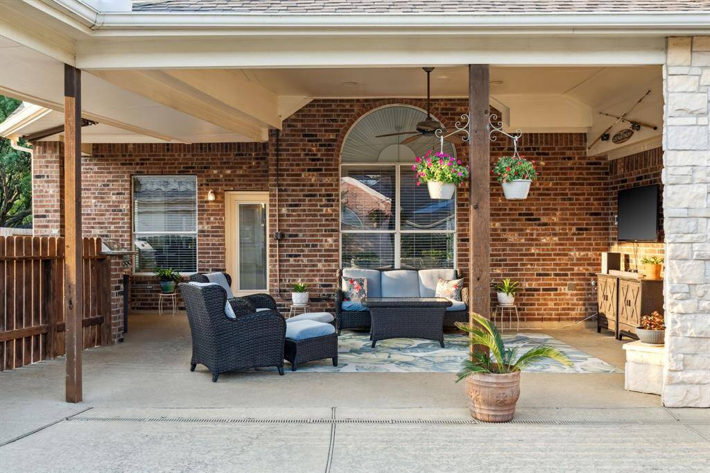 Covered back patio with breezy ceiling fan.
