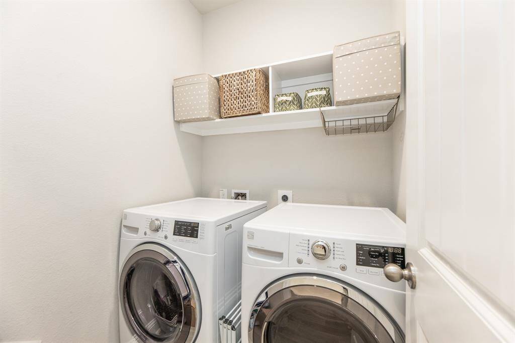 Laundry room located on the first floor, along with convenient shelf.