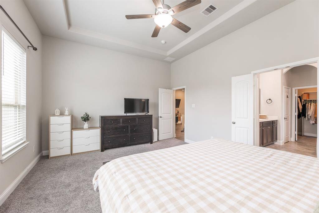 Primary bedroom with ensuite bathroom and walk in closet