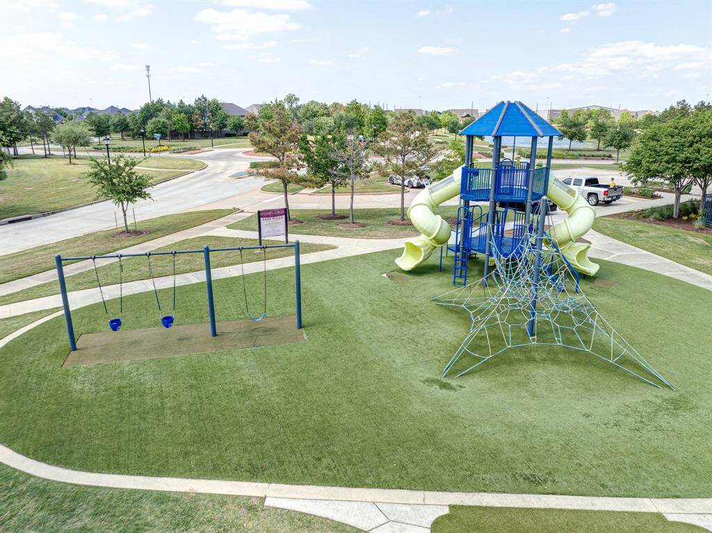 Community park with a playground, swings, climbing structure, and a slide.