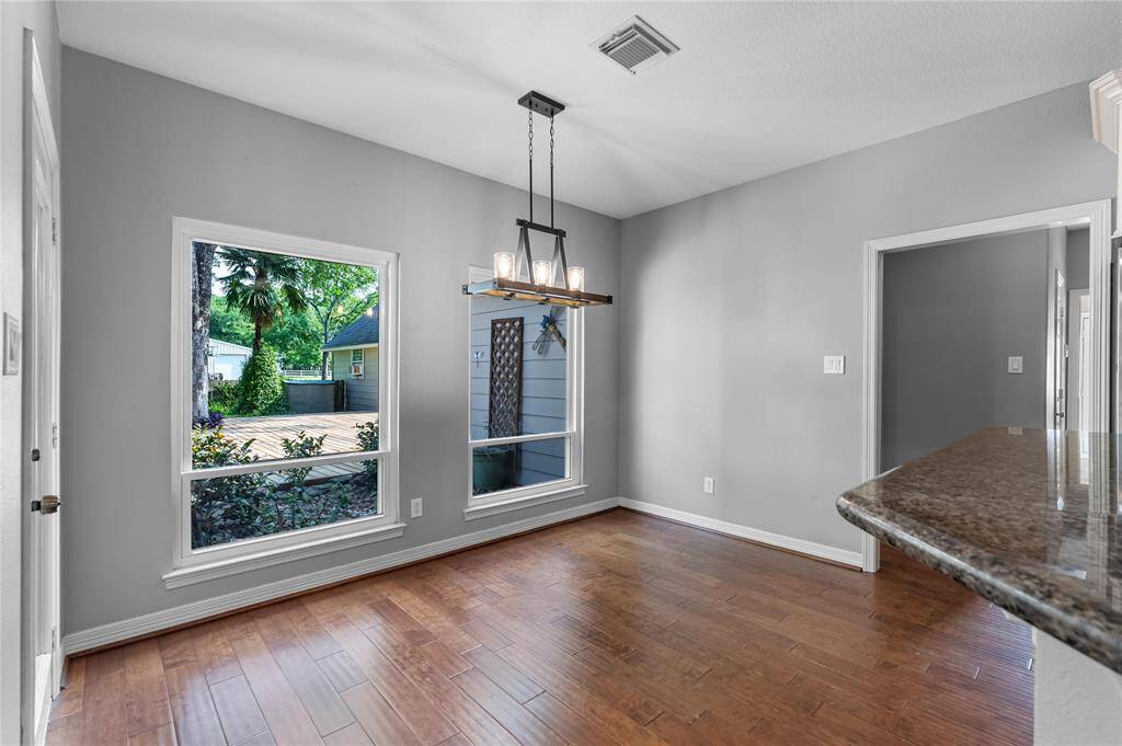 Open & bright breakfast room off of kitchen and open to den with views of pool and backyard!