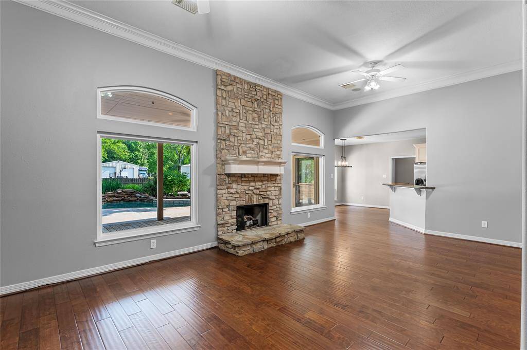 Amazing backyard and pool views from den with gorgeous fireplace & wood floors!
