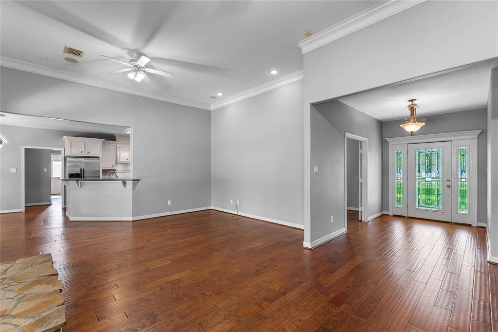 Den with views of entry looking towards formal living.