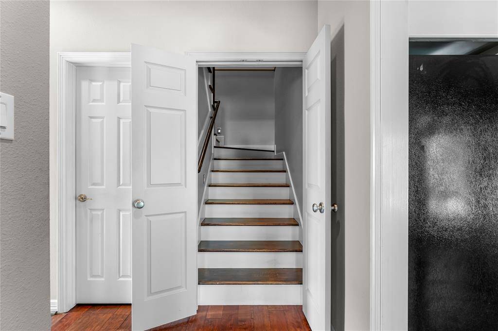 View of stairs off kitchen leading upstairs to game/flex space.  Half bath located nearby is perfect for guests!