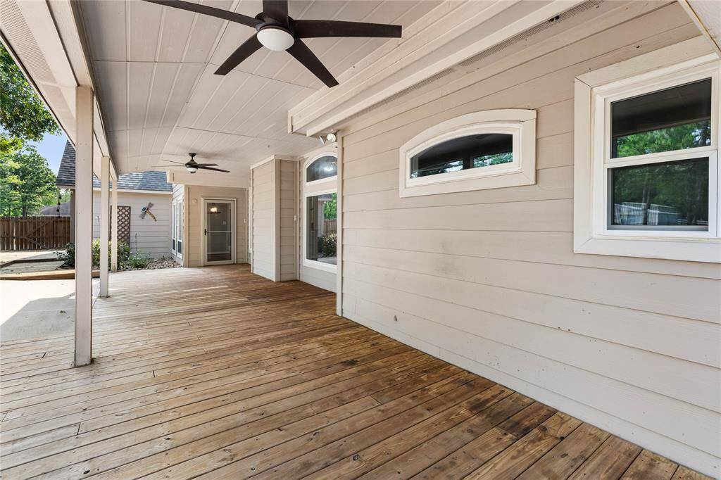 Covered back patio with ceiling fans located off the kitchen and den.