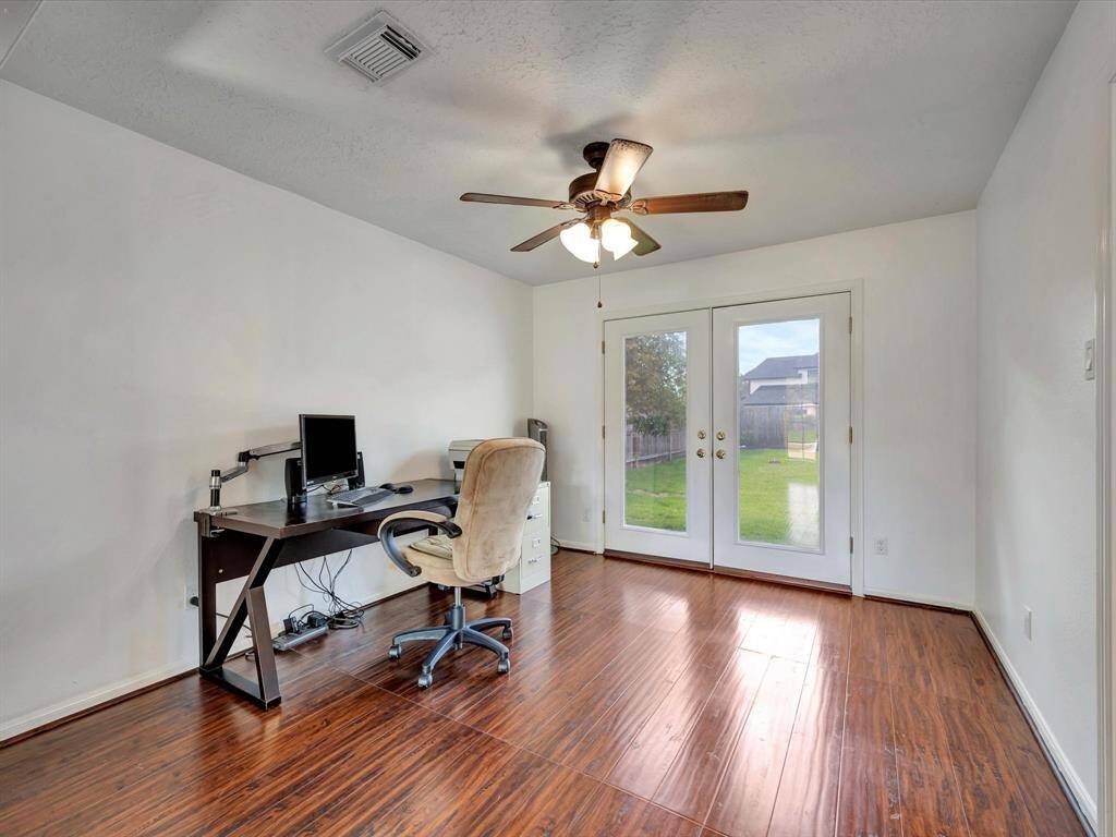 Dining room is currently being used as an office. French doors to backyard.
